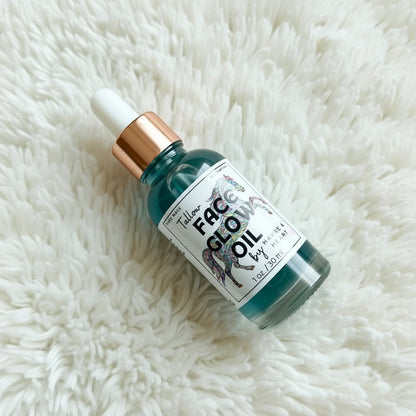 Bottle of 'Face Glow Oil' on a fluffy white surface
